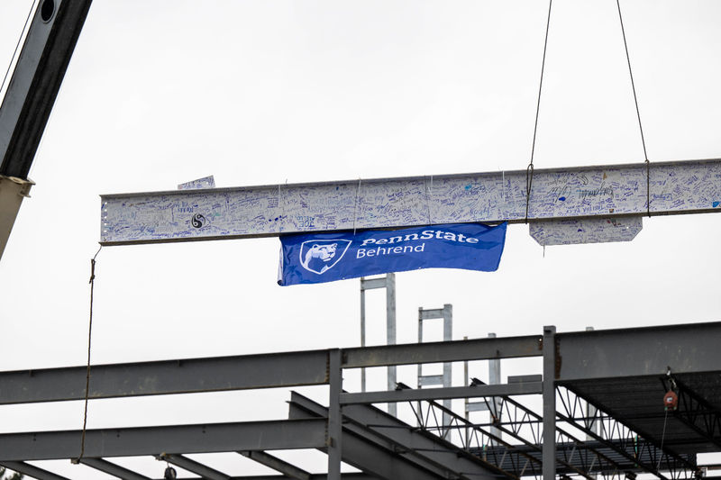 A 32-foot beam is raised at the site of Penn State Behrend's new Erie Hall.