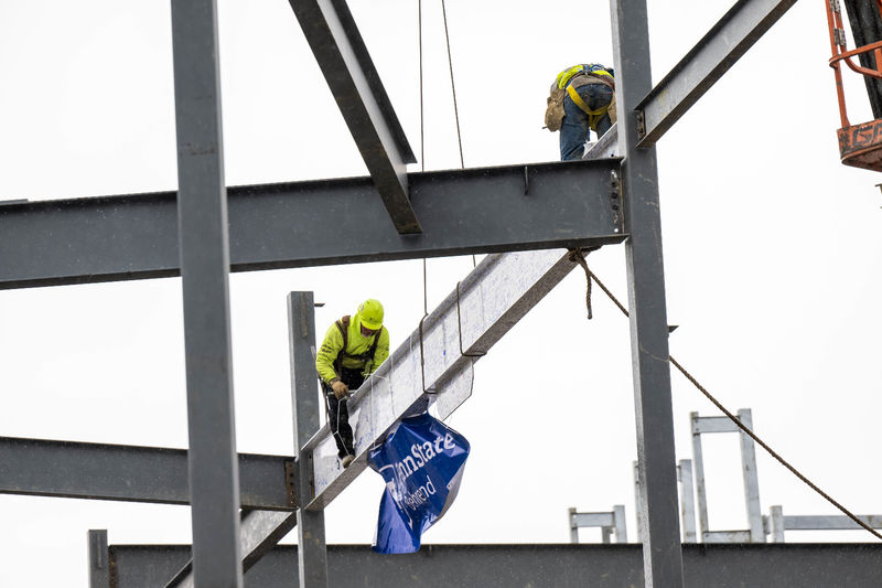 Steelworkers set a beam into place at the site of Penn State Behrend's new Erie Hall.