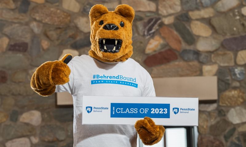 The Nittany Lion poses with a Class of 2023 sign