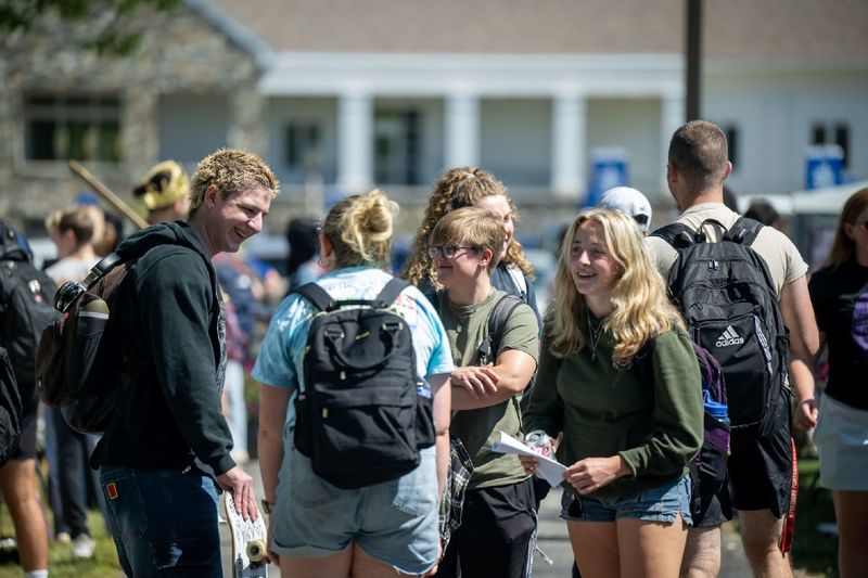 Students gather in groups to talk at the Penn State Behrend Discovery Fair.