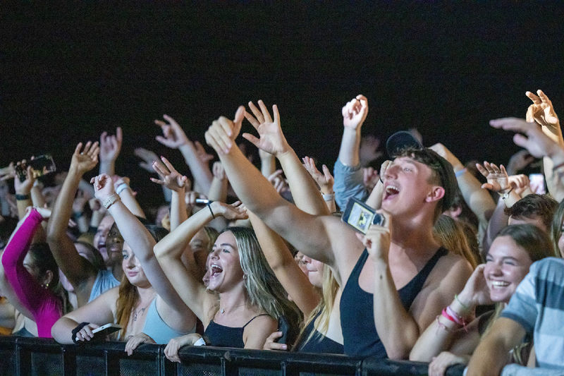 Students cheer in the front row of a Waka Flocka Flame concert at Penn State Behrend.