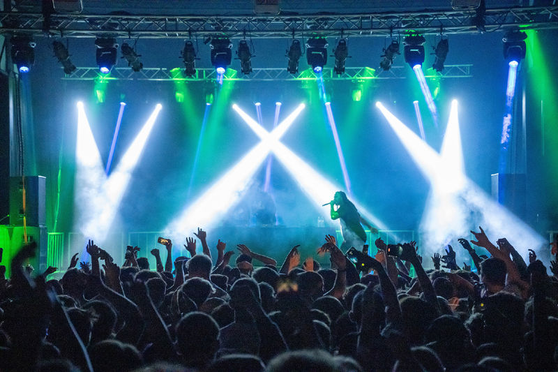 Waka Flocka Flame performs under a spotlight at Penn State Behrend.