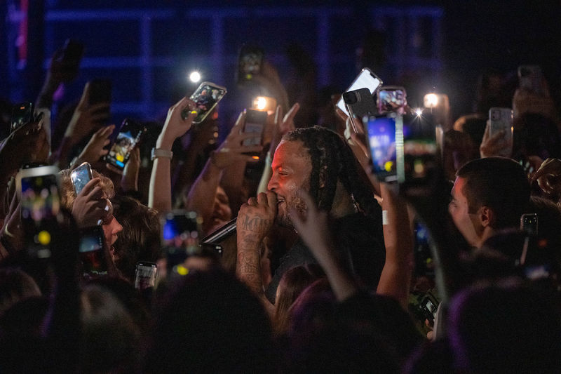 The rapper Waka Flocka Flame is surrounded by fans after entering the crowd during a concert at Penn State Behrend.