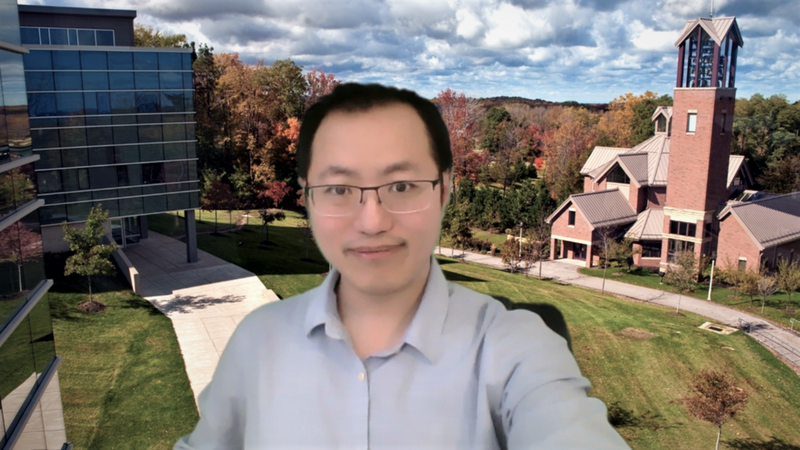 Richard Zhao, an assistant professor at Penn State Behrend, uses a custom backdrop of the Behrend campus during a class on Zoom.
