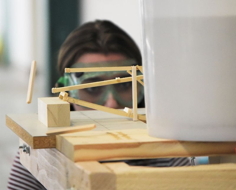 A piece of wood pops off a model bridge during the Science Olympiad at Penn State Behrend.