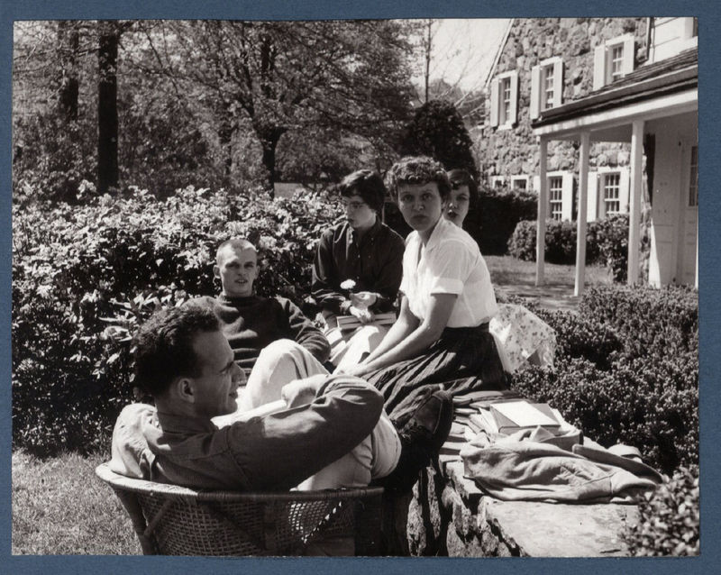 Students relax outside Glenhill Farmhouse in the early days of Behrend Center