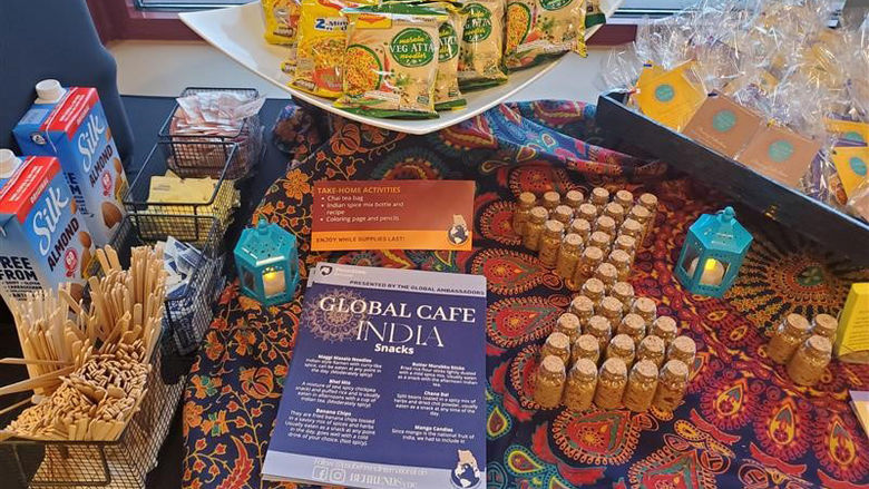 Table display with food and handouts for Global Café India