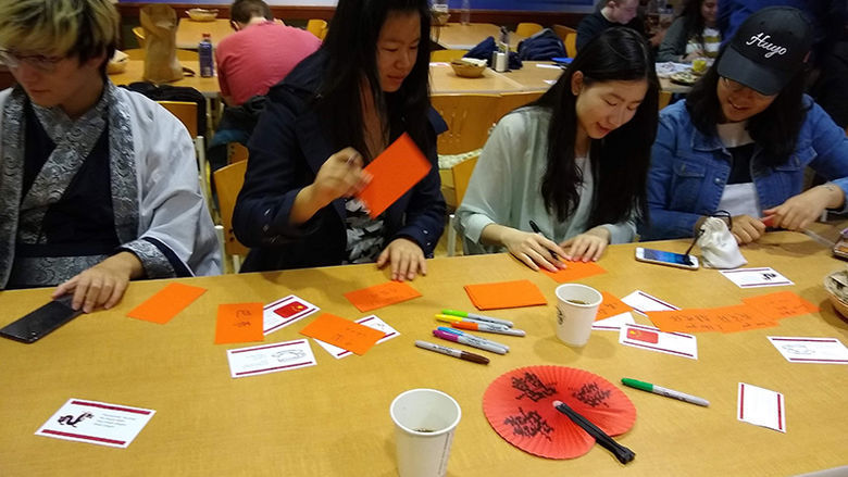 Students writing names in Mandarin