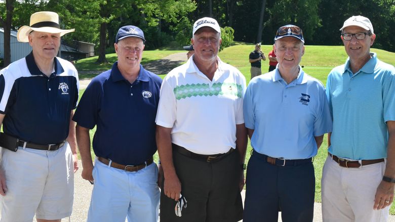 Members of the 1968-69 Penn State Behrend men's basketball team Duane May (far left), Eric Obert, Doug Zimmerman, Roger Sweeting (coach) and Dan Fry pose for a photo during the Herb Lauffer Memorial Golf Tournament.