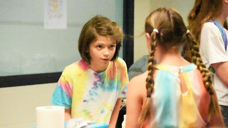 A 12-year-old girl interviews another student during a Penn State Behrend College for Kids program.