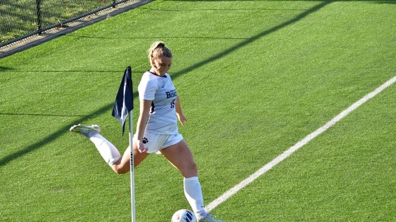 A Penn State Behrend women's soccer player prepares to kick a corner kick.