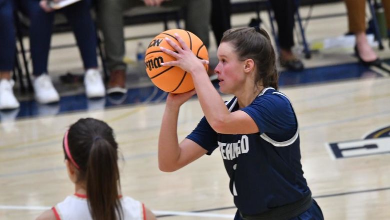 A player for the Penn State Behrend women's basketball team attempts a free throw.