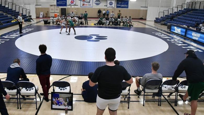 Two wrestlers grapple during a match at Penn State Behrend