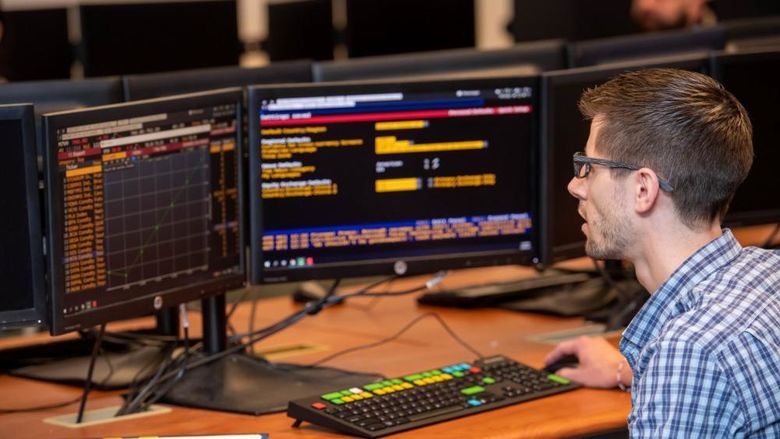 A student in Penn State Behrend's Black School of Business tracks a stock's performance on a Bloomberg Terminal.