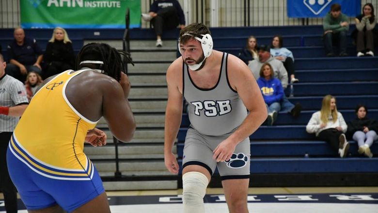 Penn State Behrend wrestler Kyle Trim faces off against an opponent.