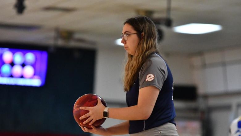 A member of the Penn State Behrend women's bowling team prepares to roll the ball.