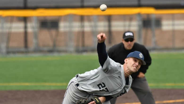 A pitcher for the Penn State Behrend baseball team throws the ball.