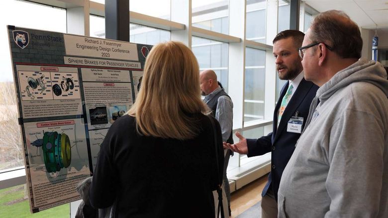 A student explains his capstone engineering project to visitors at Penn State Behrend's Fasenmyer Engineering Design Conference.
