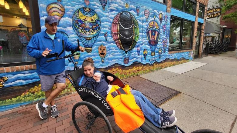 Dan and Emma Perritano pose in front of a mural in Vermont.