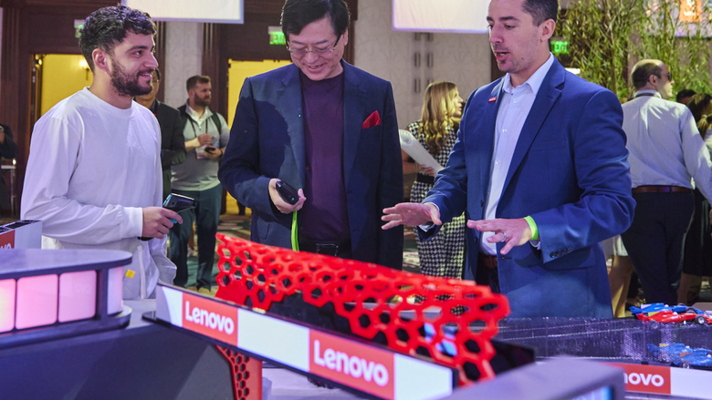 Penn State Behrend alumnus Jon Wolff talked with Lenovo CEO Yang Yuanqing at a model racetrack.