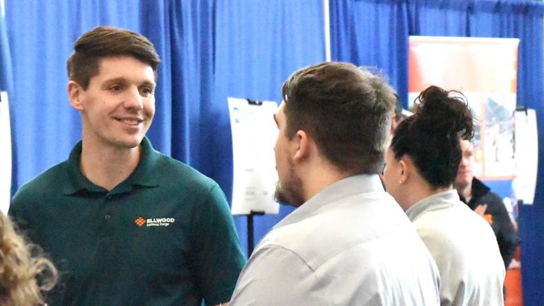 A recruiter for Ellwood National Forge talks with students at Penn State Behrend's career fair.