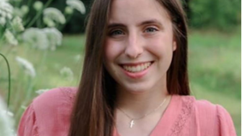 Photo of Chelsea Grucza in pink shirt in outdoor setting