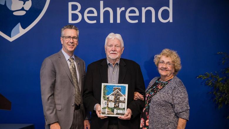 Penn State Behrend Chancellor Ralph Ford presents the Behrend Distinguished Alumni Award to John B. Lloyd and Jean Chambers Lloyd.