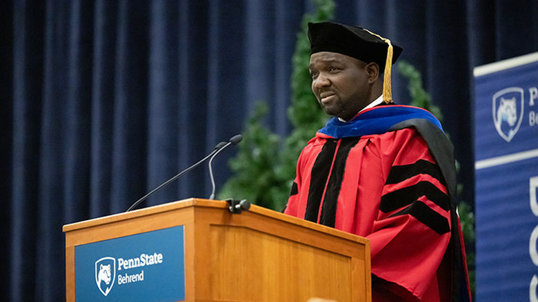 A faculty member addressing graduates at commencement