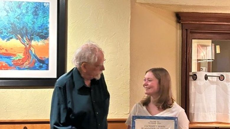 Carlina Edinger accepted the Zachary T. Irwin Humanitarian Award in 2025 from Dr. Irwin
