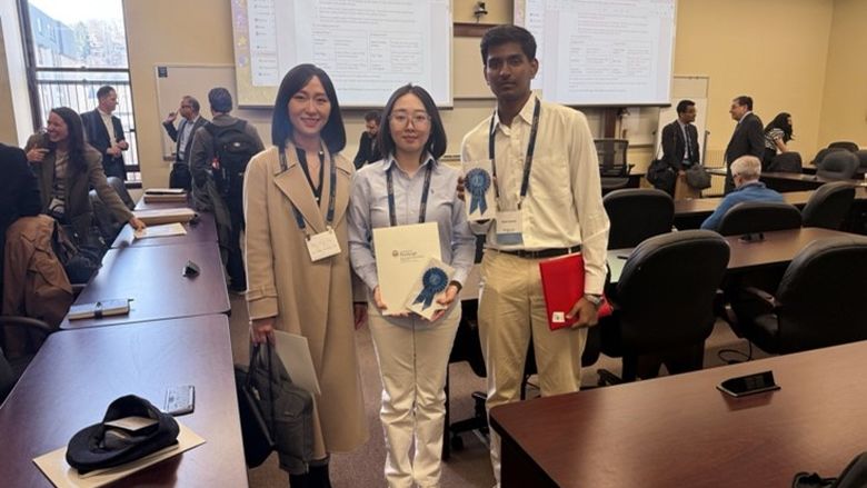 Photo of Dr. Ying Cao and students Jiaqiang Wu and Ritvik Komma holding an award.