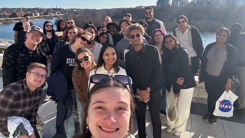 Students in front of the view from the Kennedy Center balcony.