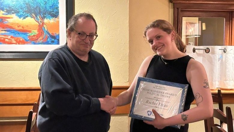 The first winner was Rachel Pineo seen here being congratulated by Dr. Bob Roecklein, who teaches political theory.