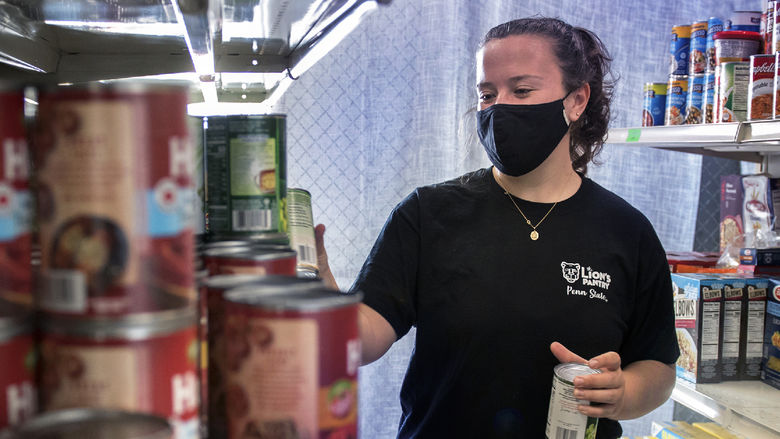 Emily Griffin stocking shelves at Lions Pantry