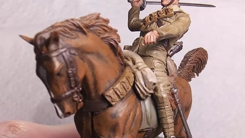 A detail of a miniature figure of a soldier on a horse.