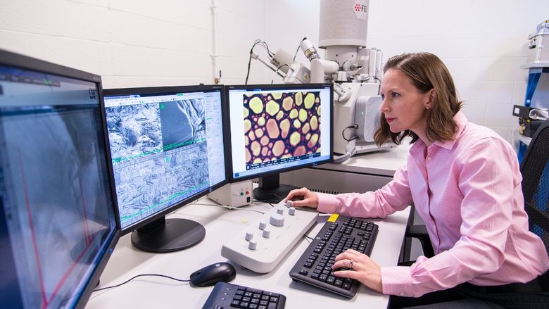 Penn State Behrend assistant professor Alicyn Rhoades works on the colleges environmental scanning electron microscope.