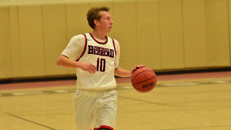 Penn State Behrend basketball player Andy Niland dribbles the ball.