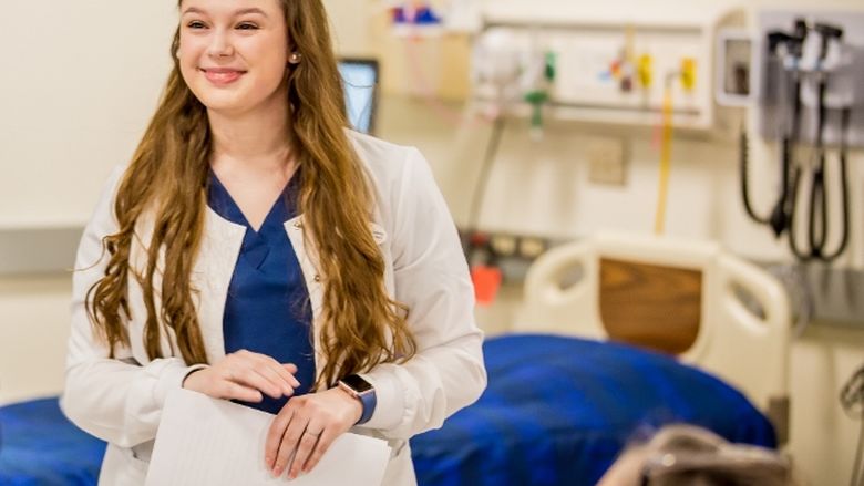 Penn State Behrend nursing graduate Angela Jenkins stands in the college's rennovated nursing simulation lab.