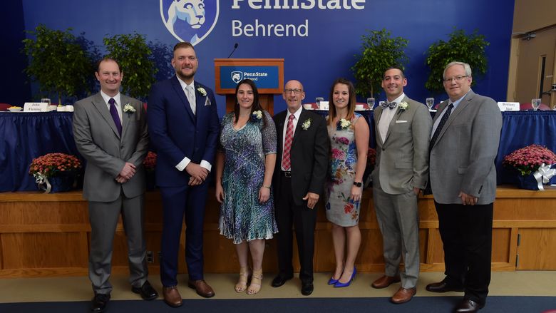 Six new members of the Penn State Behrend Athletics Hall of Fame pose with Director of Athletics Brian Streeter.