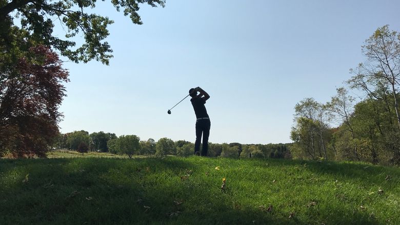The silhouette of a Penn State Behrend golfer