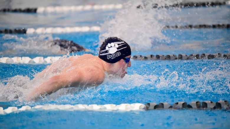 A Penn State Behrend swimmer competes in a race.