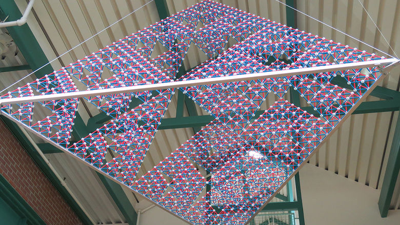 High overhead at the entrance to Roche Hall is a art—a stage-5 Sierpinski tetrahedron that models a fractal with infinite triangles—created by student members of the School of Science Math Club.