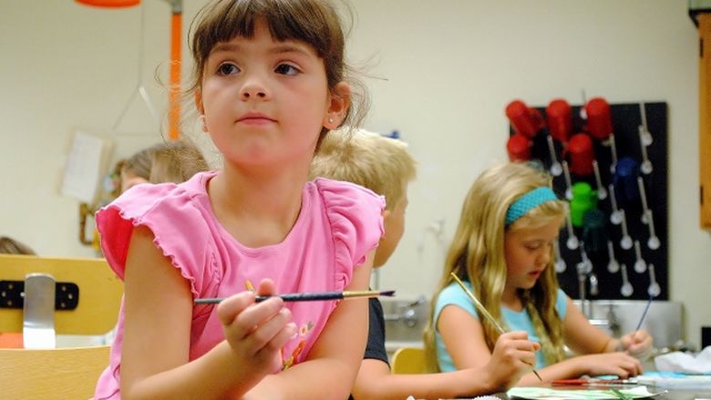 A girl paints during a Penn State Behrend College for Kids program.