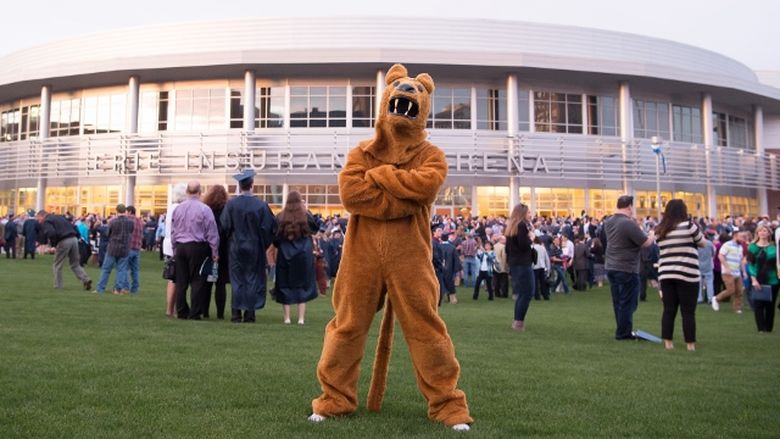 The Nittany Lion poses outside a Penn State Behrend commencement ceremony.