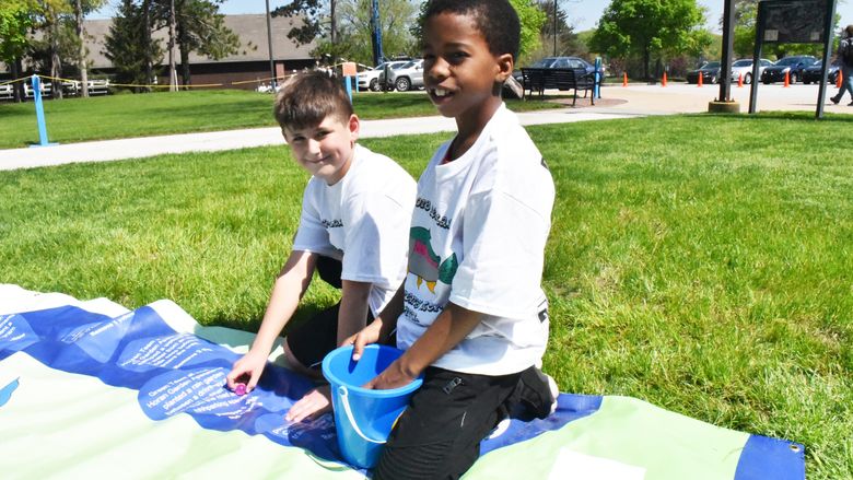 Amari Eaddy, right, and David Burdak participate in an Interactive Watershed Game at the Children's Water Festival, held May 17 at Penn State Behrend.
