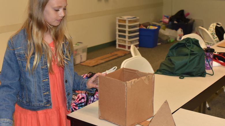 Linnea Henderson works to construct a dream home during the "Engineer and Build Your Dream Home" class at Penn State Behrend's College for Kids. 