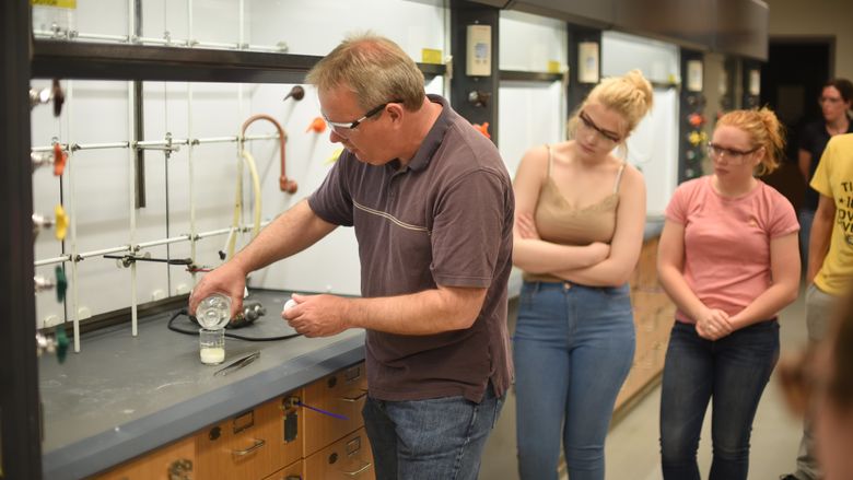 Jerry Magraw, a senior technician, instructs McDowell High School students on creating a compound containing an ester during a chemistry outreach event held Wednesday, May 17, at Penn State Behrend.