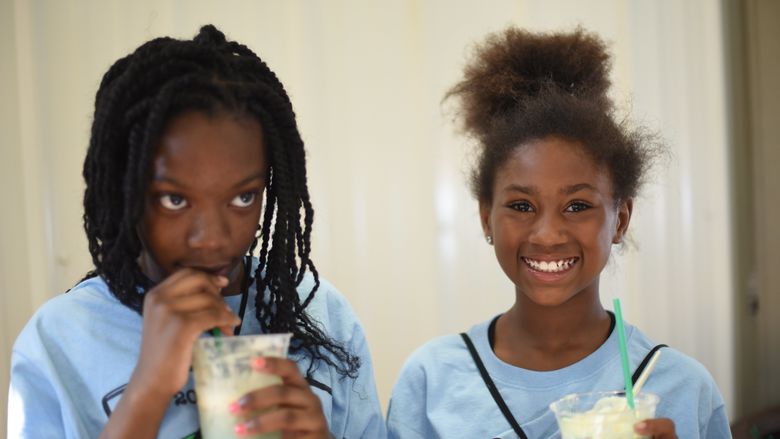 Denanyae Evans, left, and Diora Jones, both fifth-grade students at Pfeiffer-Burleigh School, posed with their edible aquifers.