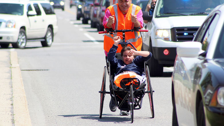 Dan Perritano pushes his daughter Emma in a specialized wheelchair.