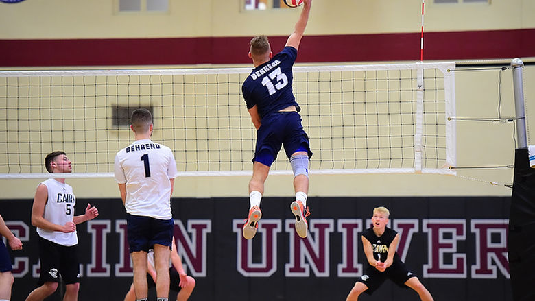 Penn State Behrend volleyball player Dillon Hildebrand leaps to hit the ball.
