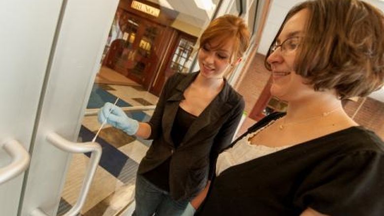 Researchers test for bacteria on a door handle in the Reed Union Building.